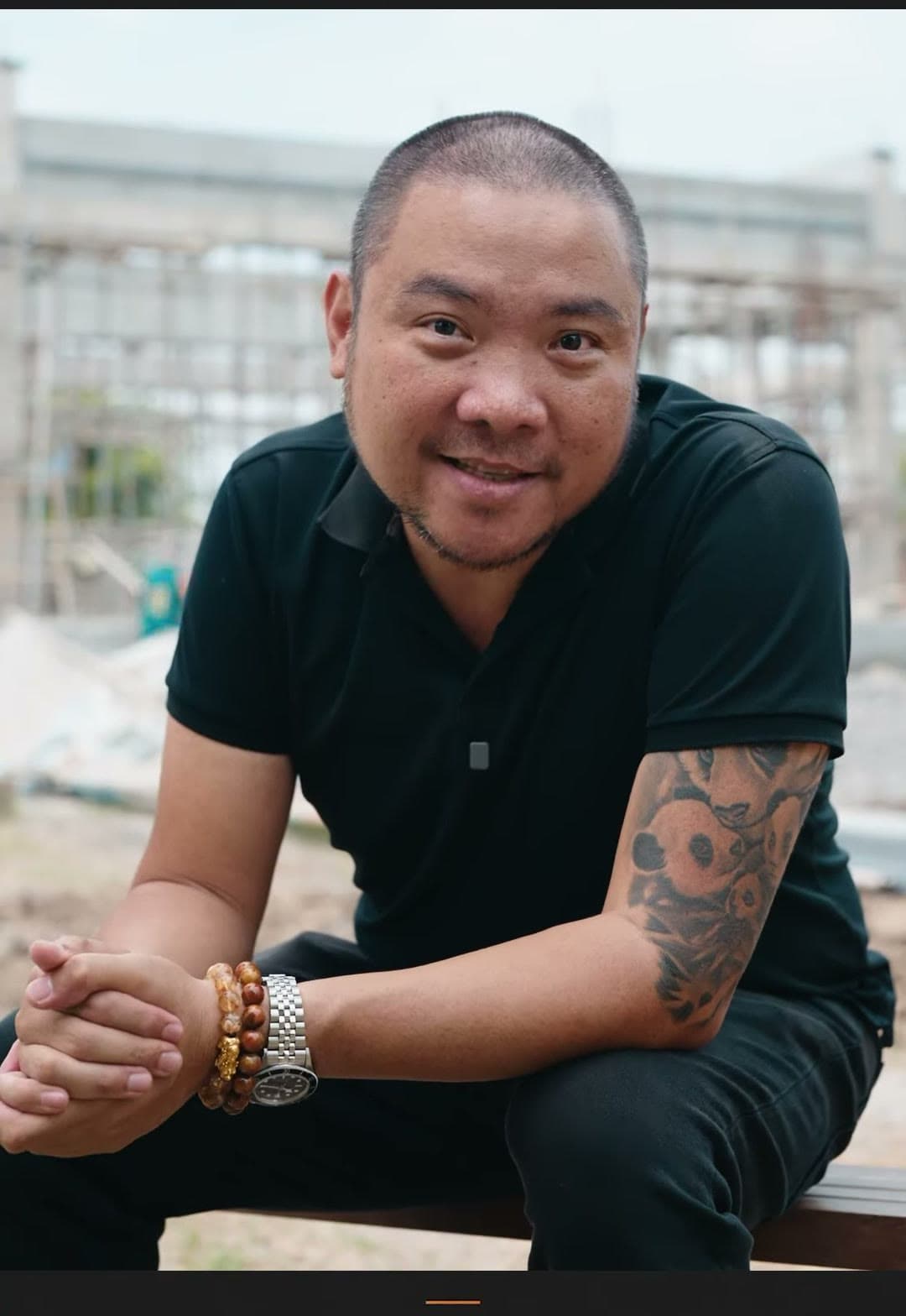 Kuya Erick seated on a construction site