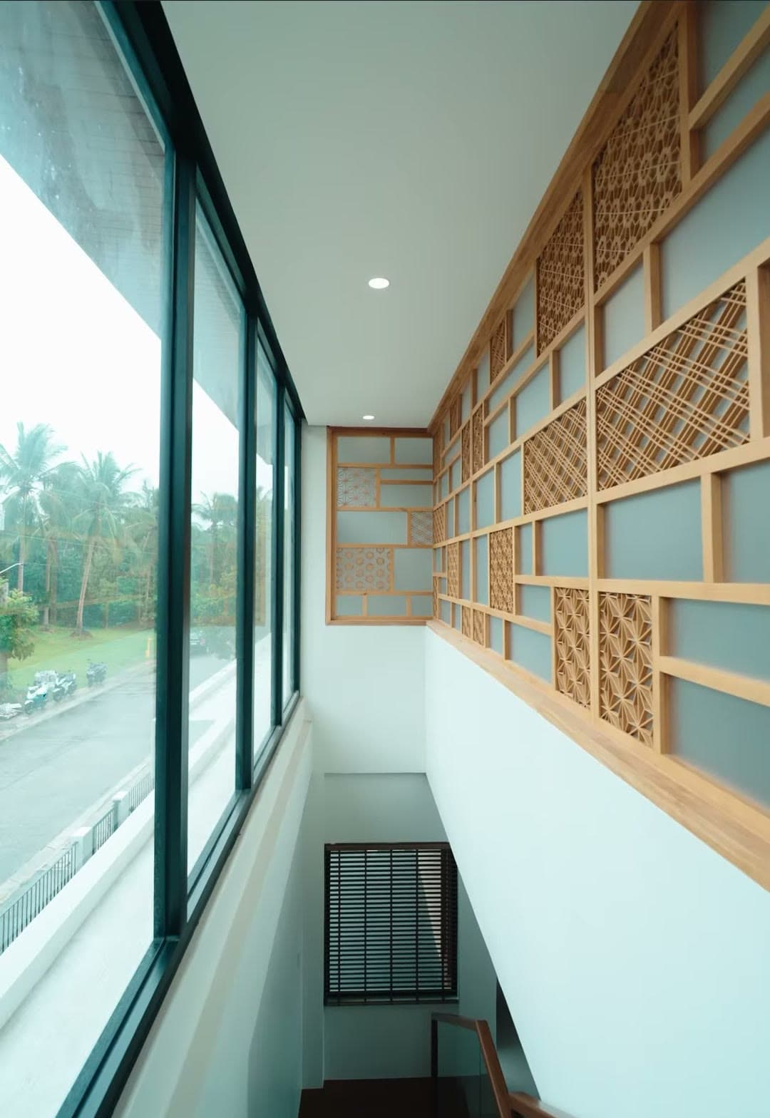 Wood lattice screen beside tall windows