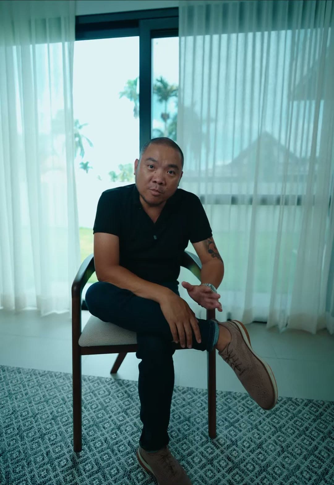 Kuya Erick seated inside a Keystone home