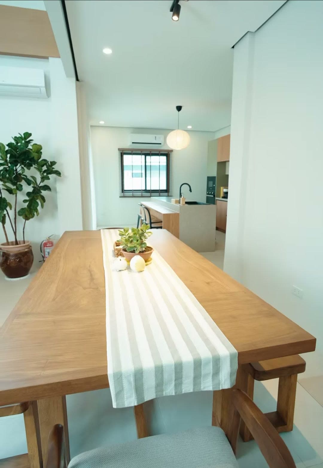 Solid-wood dining table beside the kitchen